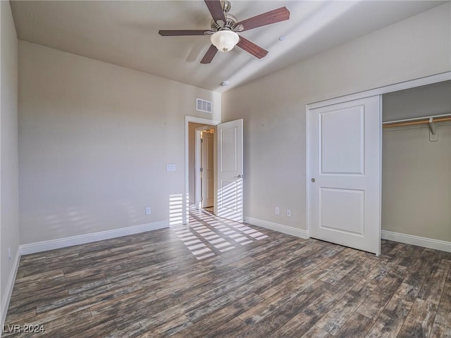 unfurnished bedroom featuring ceiling fan, a closet, and dark hardwood / wood-style floors