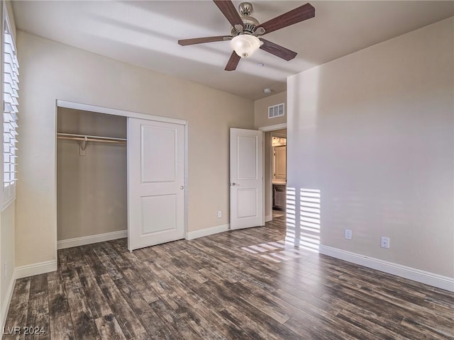 unfurnished bedroom with ceiling fan, a closet, and dark hardwood / wood-style floors