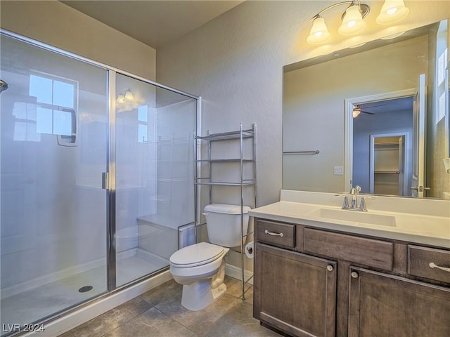 bathroom with toilet, an enclosed shower, ceiling fan, and vanity