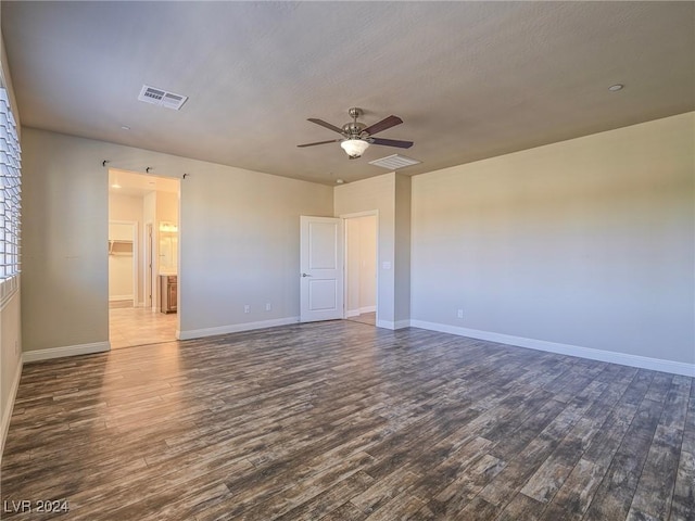 spare room featuring ceiling fan, dark hardwood / wood-style flooring, and a textured ceiling