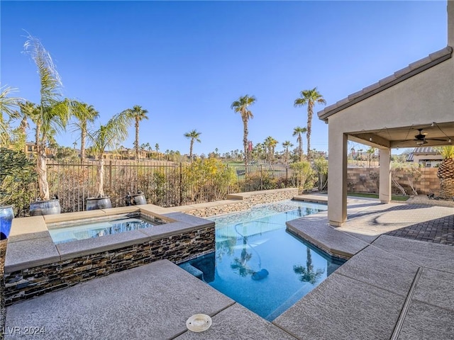 view of pool featuring ceiling fan and an in ground hot tub