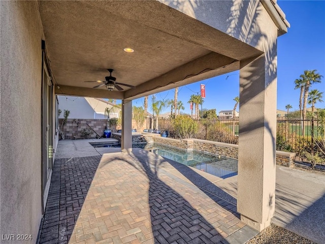 view of patio featuring ceiling fan and a fenced in pool