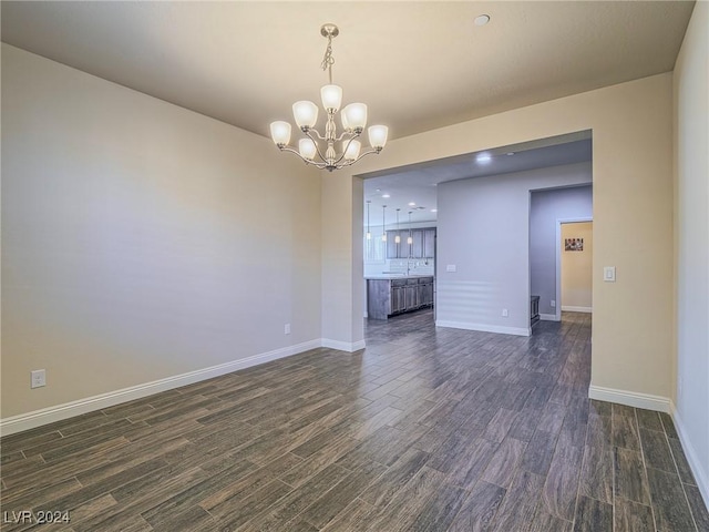 interior space featuring dark hardwood / wood-style flooring and a chandelier