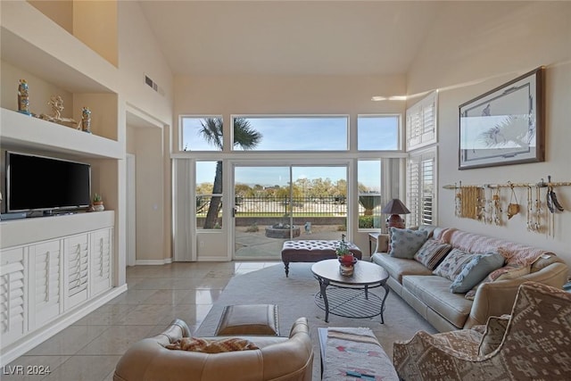 tiled living room with a high ceiling