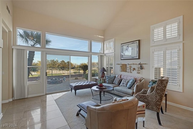 living room featuring light tile patterned flooring and a high ceiling