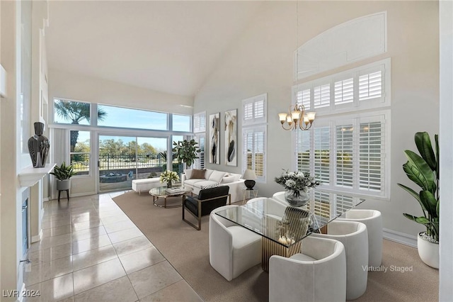 interior space featuring a high ceiling, plenty of natural light, and a notable chandelier