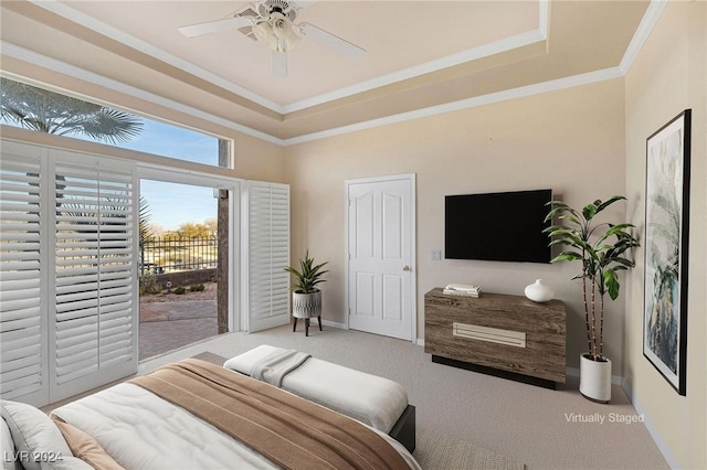 bedroom featuring crown molding, light carpet, access to outside, a tray ceiling, and ceiling fan