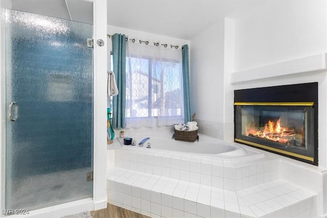 bathroom featuring hardwood / wood-style floors and plus walk in shower