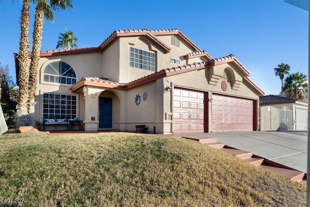 mediterranean / spanish home with a front yard