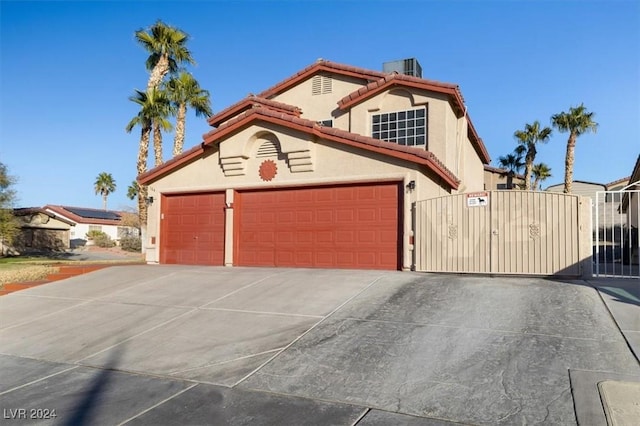 mediterranean / spanish-style home with a garage