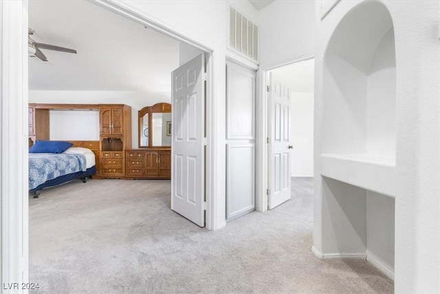 bedroom with light carpet and ceiling fan