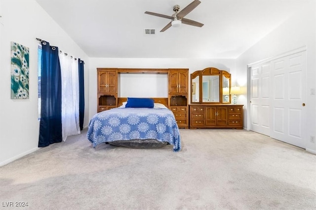 carpeted bedroom featuring ceiling fan, a closet, and vaulted ceiling