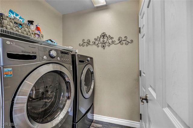 laundry room featuring washer and clothes dryer and dark wood-type flooring