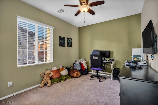 office space with light carpet and ceiling fan