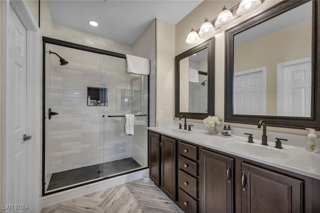 bathroom with vanity, parquet flooring, and a shower with door