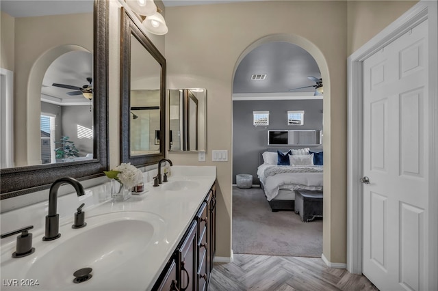 bathroom featuring ceiling fan, vanity, ornamental molding, and parquet flooring