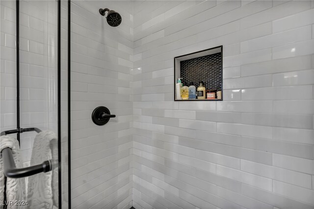 interior details featuring a tile shower