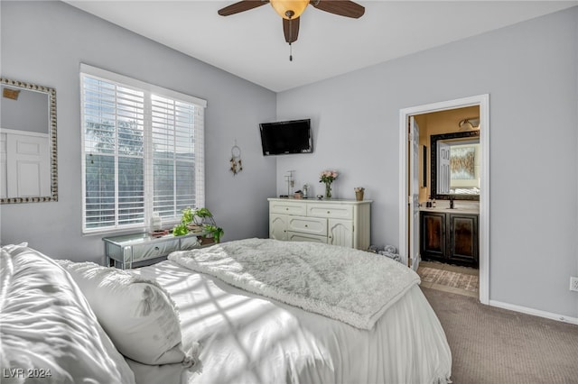 bedroom with ensuite bath, ceiling fan, and light carpet