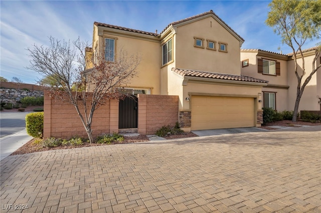 mediterranean / spanish-style house with a garage