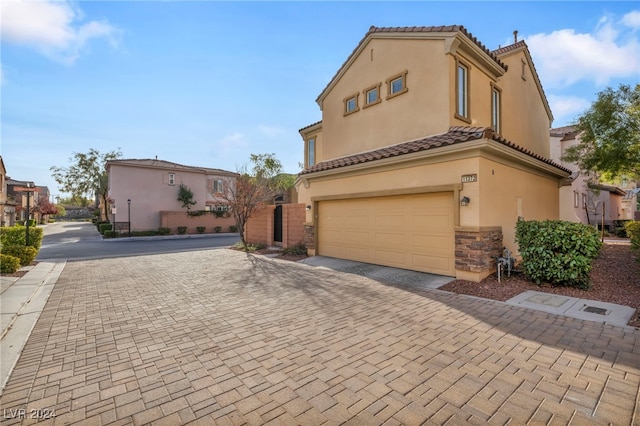 mediterranean / spanish house with a garage