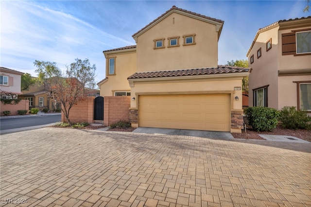 mediterranean / spanish house with a garage