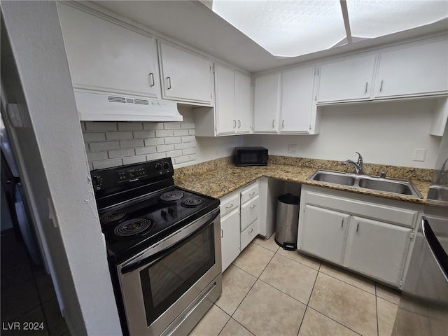 kitchen featuring white cabinetry, sink, light tile patterned floors, and stainless steel range with electric cooktop