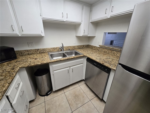 kitchen featuring white cabinets, sink, light tile patterned floors, and stainless steel appliances