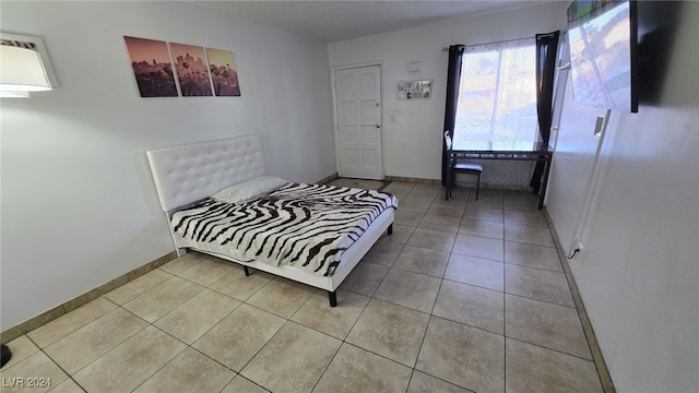 bedroom featuring light tile patterned floors