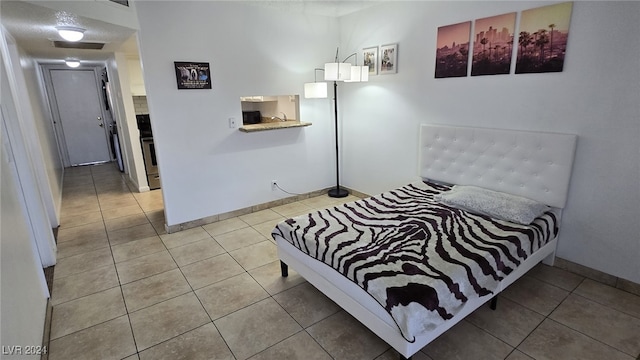 tiled bedroom with a textured ceiling