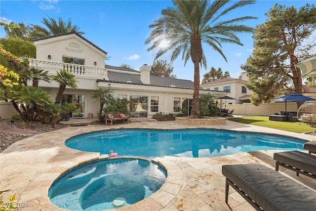 view of pool featuring a patio and an in ground hot tub