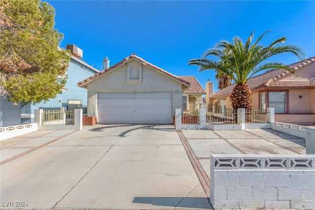 view of front of property with a garage and central air condition unit