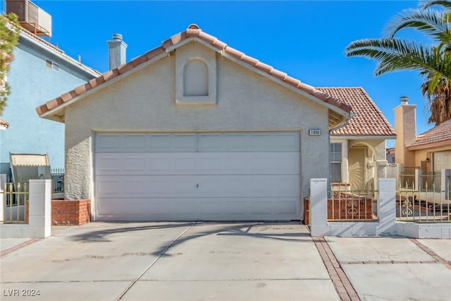 mediterranean / spanish-style home featuring a garage