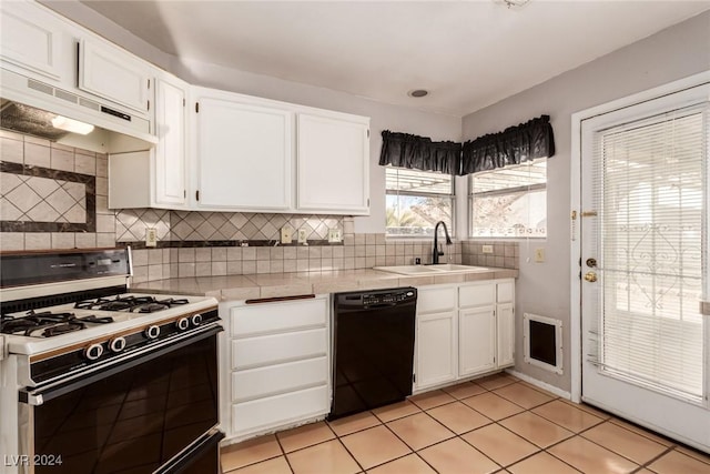 kitchen featuring dishwasher, premium range hood, sink, gas range oven, and white cabinetry