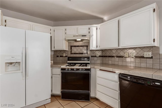 kitchen featuring gas range, white cabinetry, dishwasher, white fridge with ice dispenser, and decorative backsplash