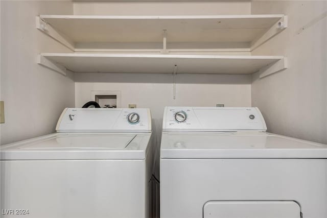 clothes washing area featuring washer and clothes dryer