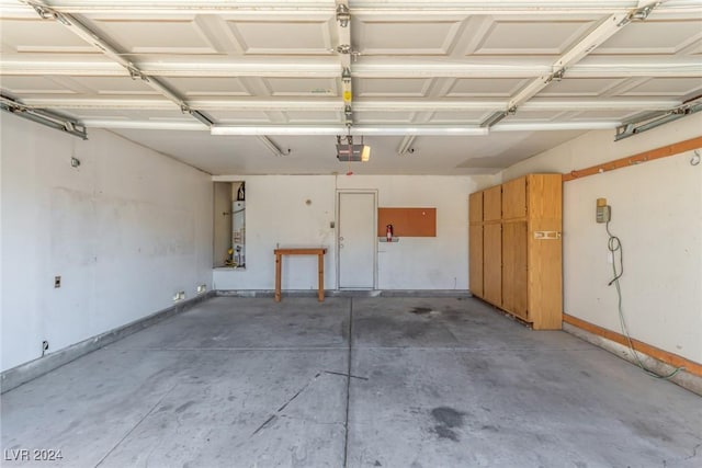 garage with water heater and a garage door opener