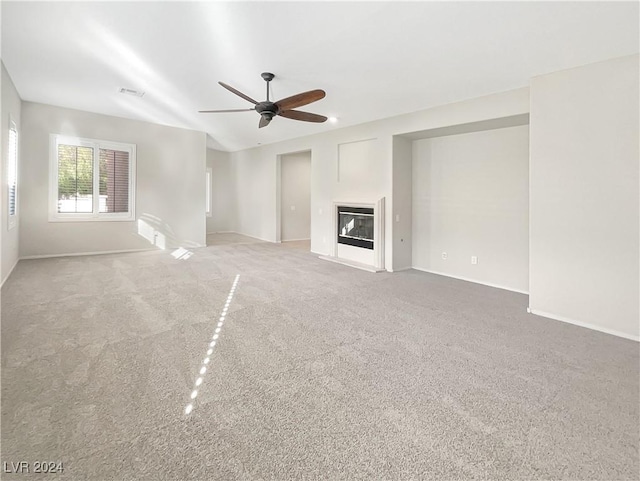 unfurnished living room with carpet floors and ceiling fan