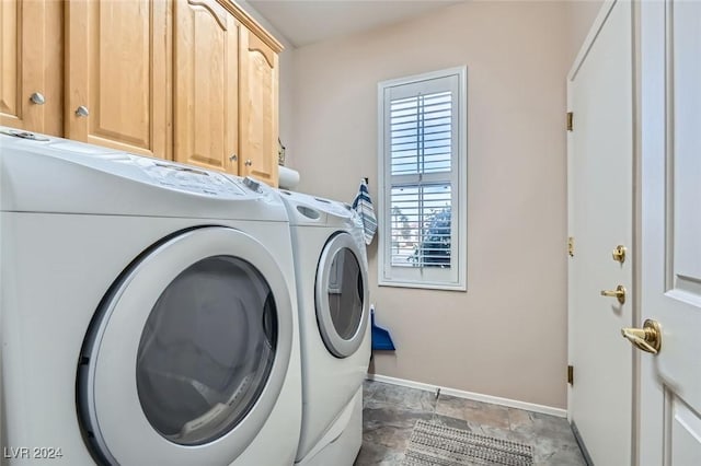 washroom with cabinets and washing machine and dryer