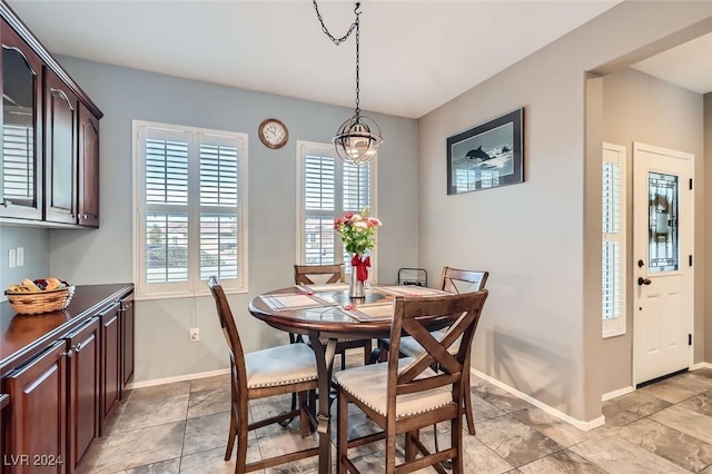 dining space with an inviting chandelier