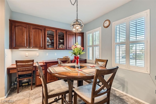 tiled dining space featuring a notable chandelier