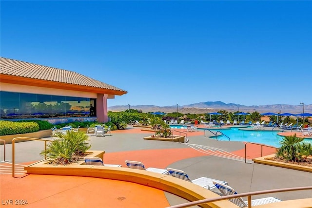 view of swimming pool with a mountain view and a patio