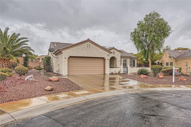 mediterranean / spanish-style home featuring central AC and a garage