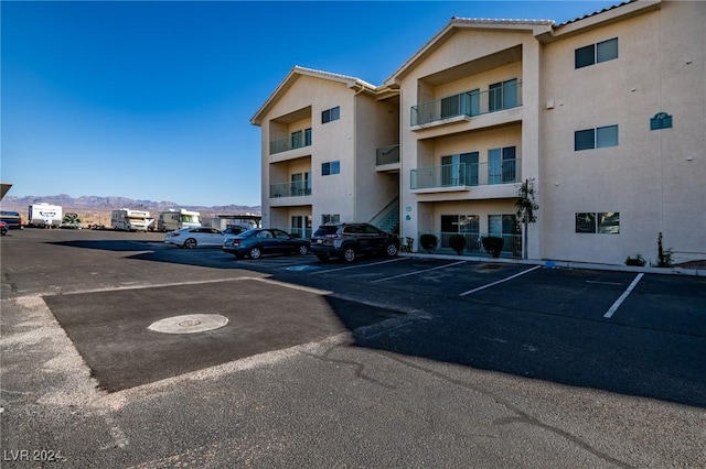 view of building exterior featuring uncovered parking