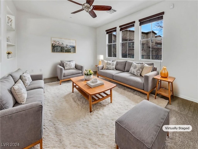 living room with ceiling fan and carpet floors