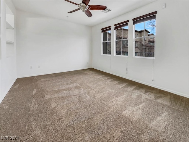 unfurnished room with carpet and ceiling fan