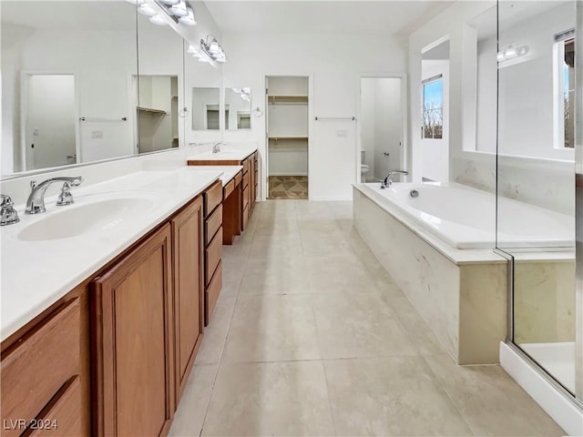 full bathroom featuring toilet, tile patterned flooring, vanity, and shower with separate bathtub