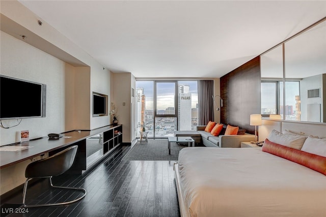 bedroom featuring expansive windows and dark wood-type flooring