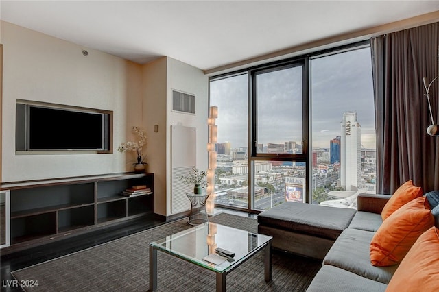 living room featuring a wealth of natural light and a wall of windows