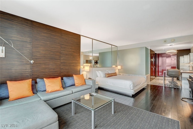 bedroom with dark hardwood / wood-style flooring