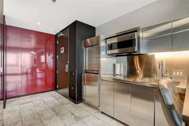 kitchen featuring stainless steel counters, sink, and appliances with stainless steel finishes